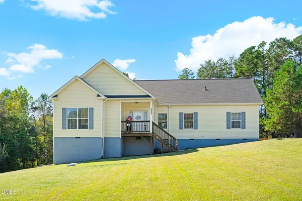 a view of a house with pool and a yard