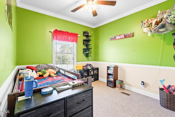 a bedroom with a bed and a chandelier