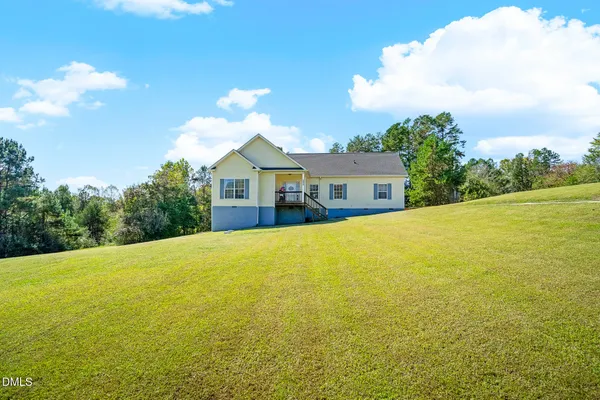 a view of a house with a yard and an outdoor space