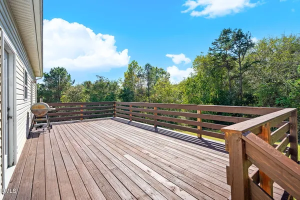 a view of deck with wooden floor and outdoor seating