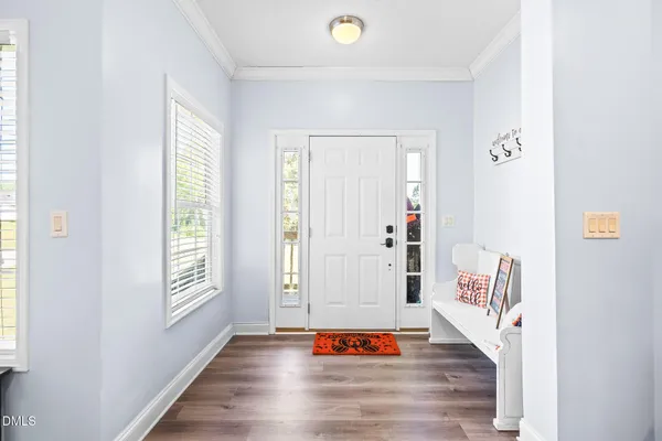 a view of an entryway with wooden floor