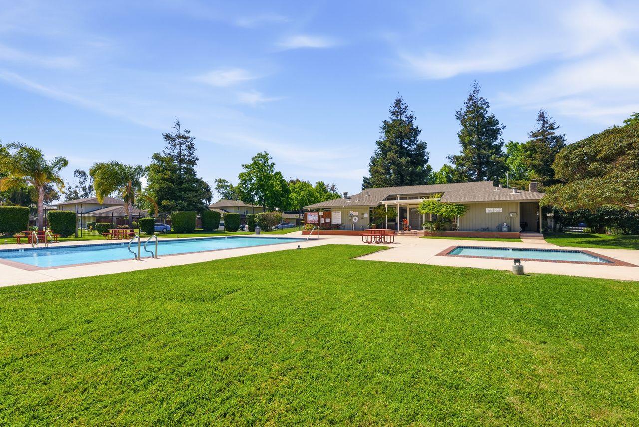 5561 Roundtree Common Fremont, CA 94538 - Photo 26 of 29 a view of a house with swimming pool and a yard