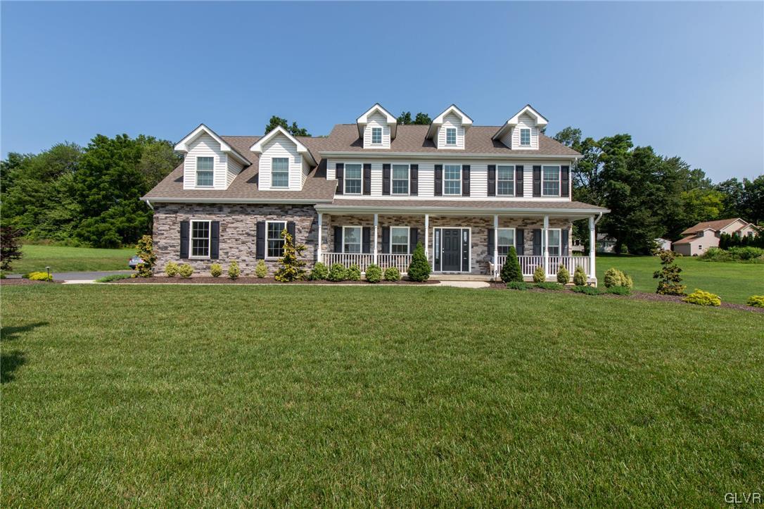 2152 Terry Road Nazareth, PA 18064 - Photo 1 of 42 a front view of a house with a garden and trees
