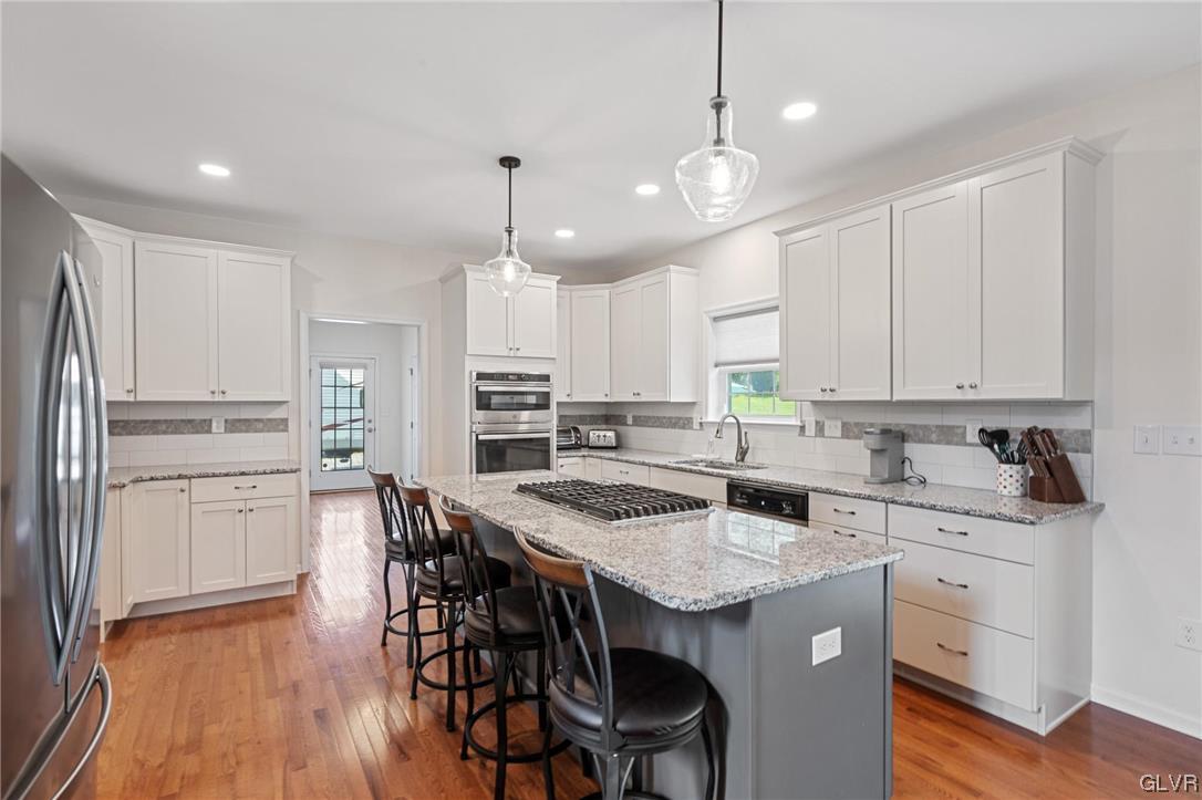 2152 Terry Road Nazareth, PA 18064 - Photo 16 of 42 a kitchen with kitchen island granite countertop a sink a center island and cabinets
