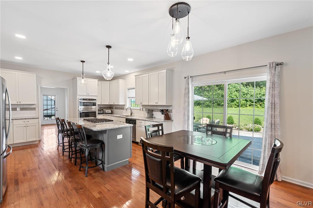 2152 Terry Road Nazareth, PA 18064 - Photo 20 of 42 a kitchen with a dining table chairs and white cabinets