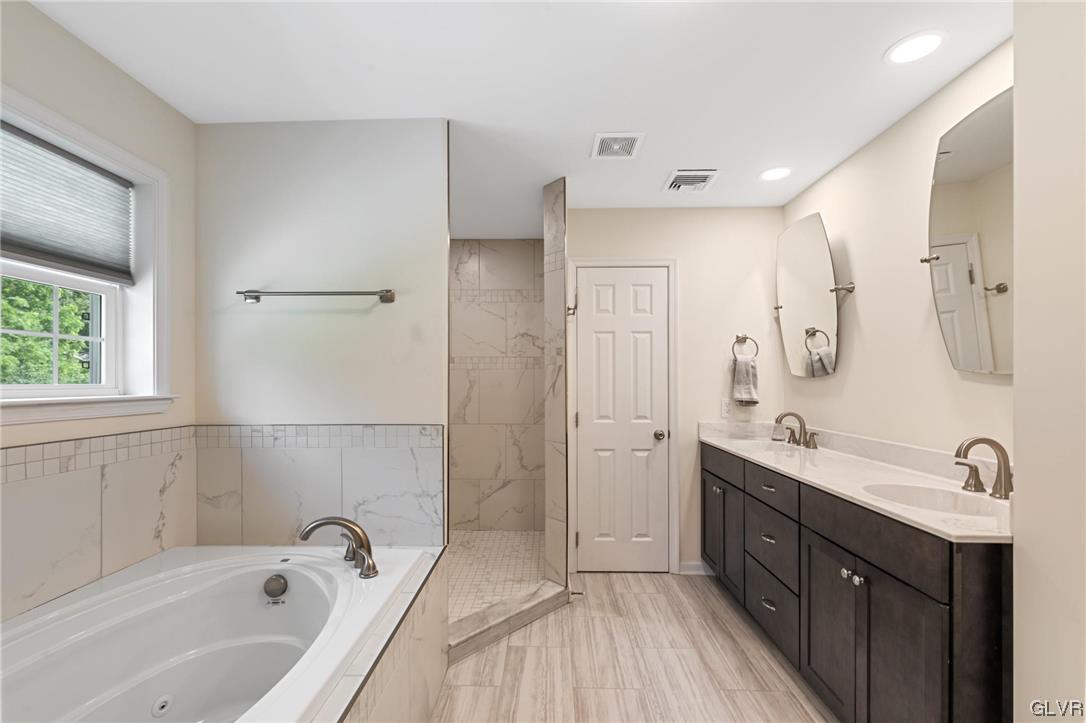 2152 Terry Road Nazareth, PA 18064 - Photo 31 of 42 a spacious bathroom with a tub sink shower and mirror