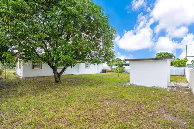 a view of a tree in front of a house with a tree