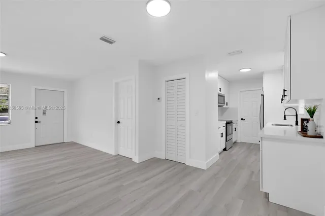 a view of a kitchen with wooden floor