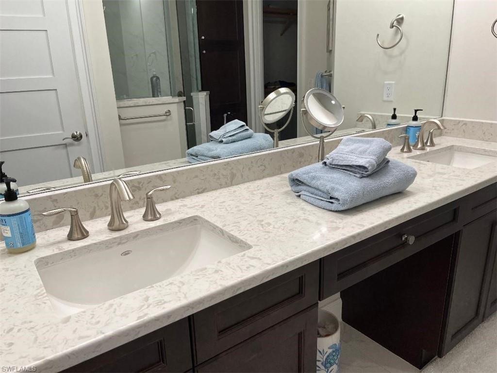 6907 Cay Court Naples, FL 34113 - Photo 11 of 15 a bathroom with a sink and a mirror