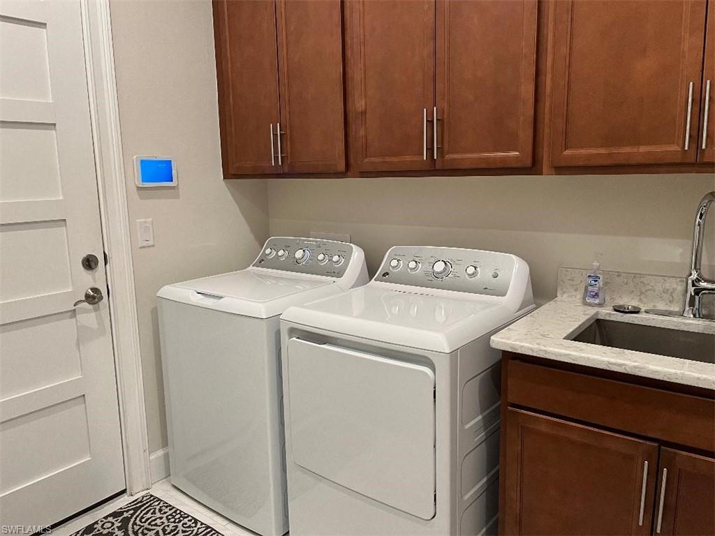 6907 Cay Court Naples, FL 34113 - Photo 14 of 15 a utility room with dryer and washer