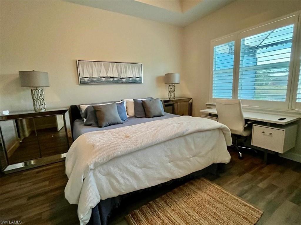 6907 Cay Court Naples, FL 34113 - Photo 9 of 15 a bed room with a bed and a night stand