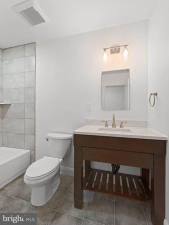 a bathroom with a sink toilet a mirror and shower