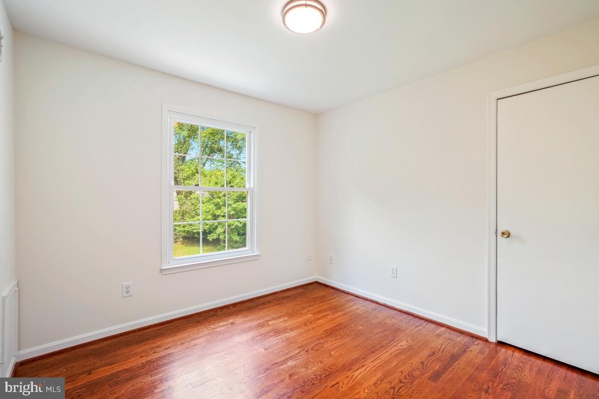 1816 Bart Drive Silver Spring, MD 20905 - Photo 15 of 38 an empty room with wooden floor and windows