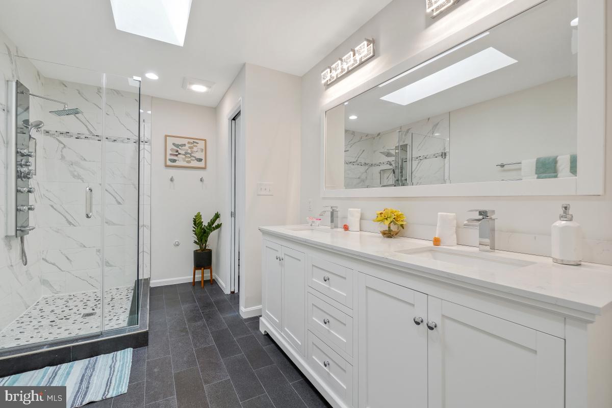 1816 Bart Drive Silver Spring, MD 20905 - Photo 19 of 38 a bathroom with a granite countertop sink a vanity and shower