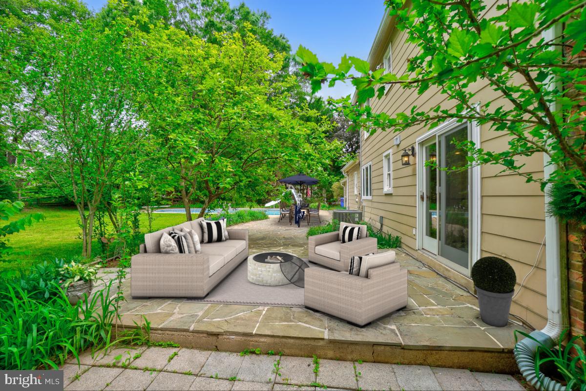 1816 Bart Drive Silver Spring, MD 20905 - Photo 33 of 38 a view of a patio with couches table and chairs and garden