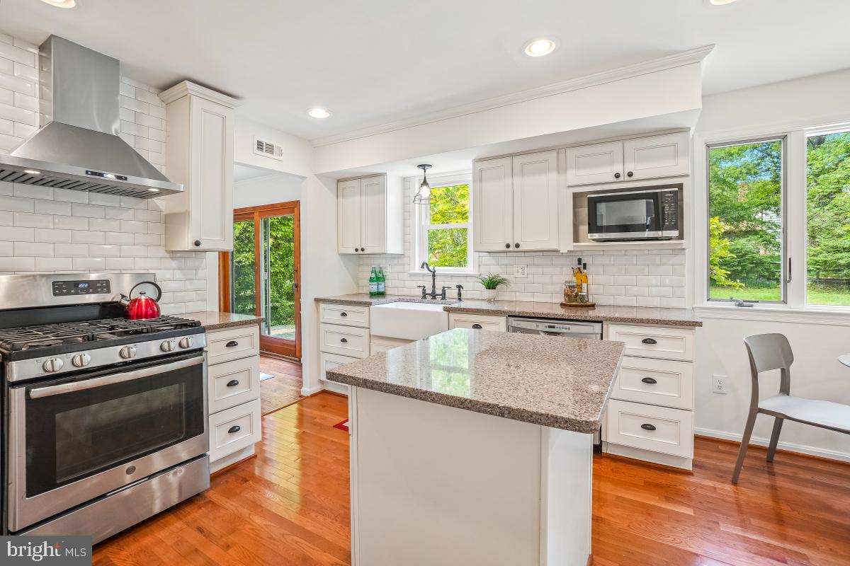 1816 Bart Drive Silver Spring, MD 20905 - Photo 7 of 38 a kitchen with stainless steel appliances granite countertop a stove a sink and a refrigerator