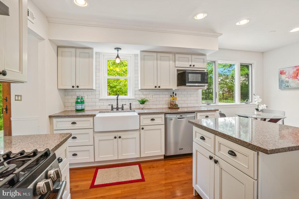 1816 Bart Drive Silver Spring, MD 20905 - Photo 9 of 38 a kitchen with white cabinets and window