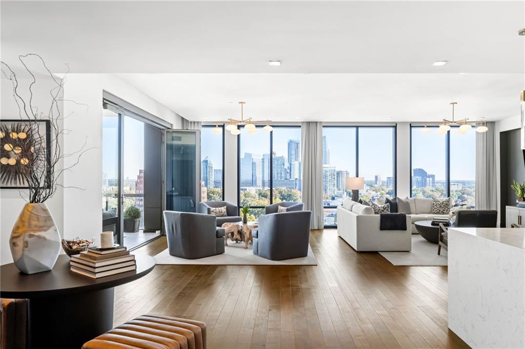 a living room with furniture and floor to ceiling windows