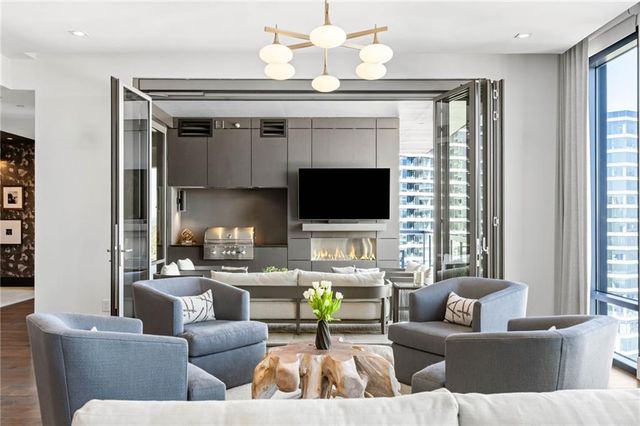 a living room with fireplace furniture and a flat screen tv
