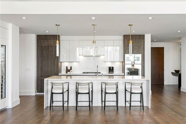 a kitchen with a table chairs refrigerator and cabinets