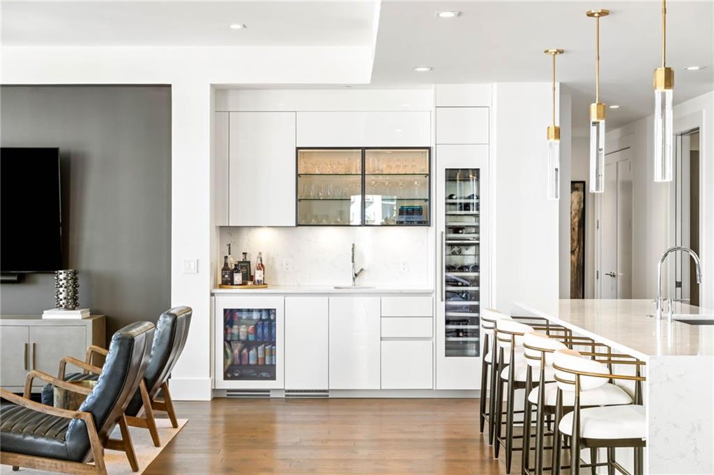 3107 Peachtree Road Northeast, Unit 1402 Atlanta, GA 30305 - Photo 20 of 72 a living room with a couch and a flat screen tv