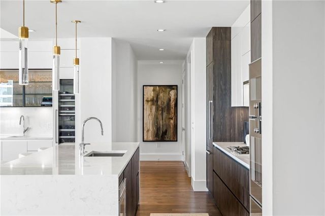 a kitchen with a refrigerator and a sink