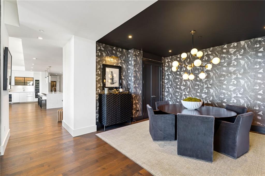 3107 Peachtree Road Northeast, Unit 1402 Atlanta, GA 30305 - Photo 26 of 72 a living room with couches and kitchen view with wooden floor