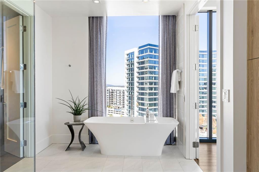 3107 Peachtree Road Northeast, Unit 1402 Atlanta, GA 30305 - Photo 35 of 72 a bathroom with a bathtub and window