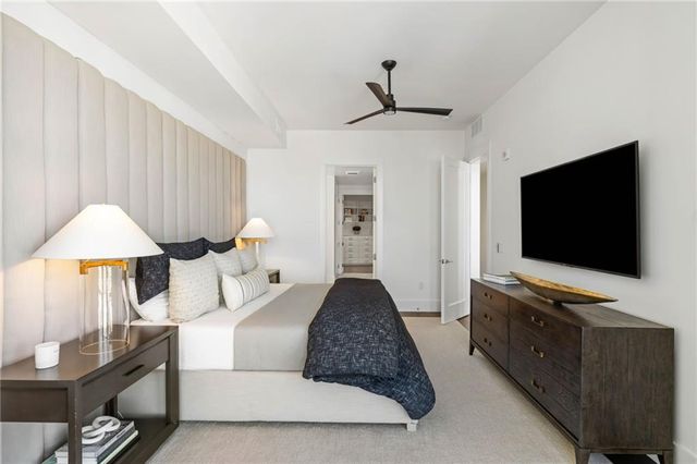 a bedroom with a large bed and a balcony view