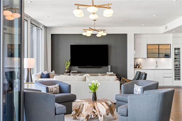 a living room with furniture a fireplace and a flat screen tv