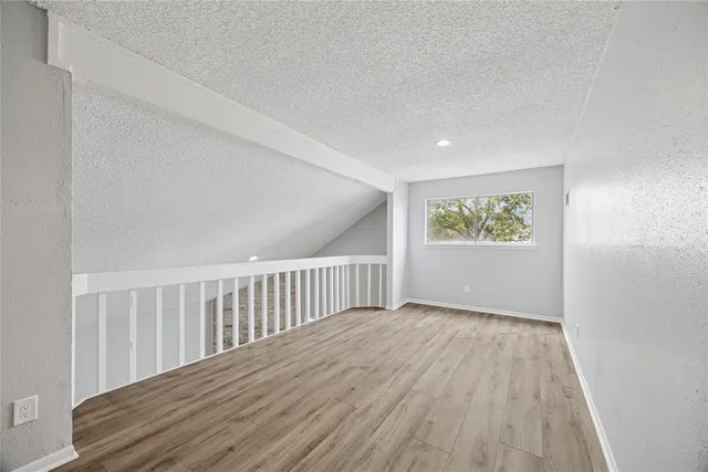 a view of wooden floor and a window in a room