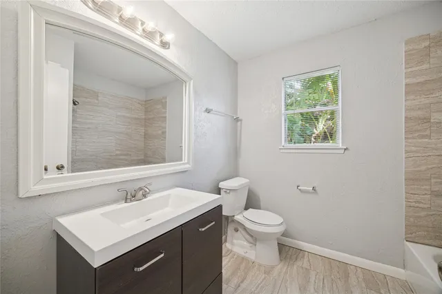 a bathroom with a sink toilet and a mirror