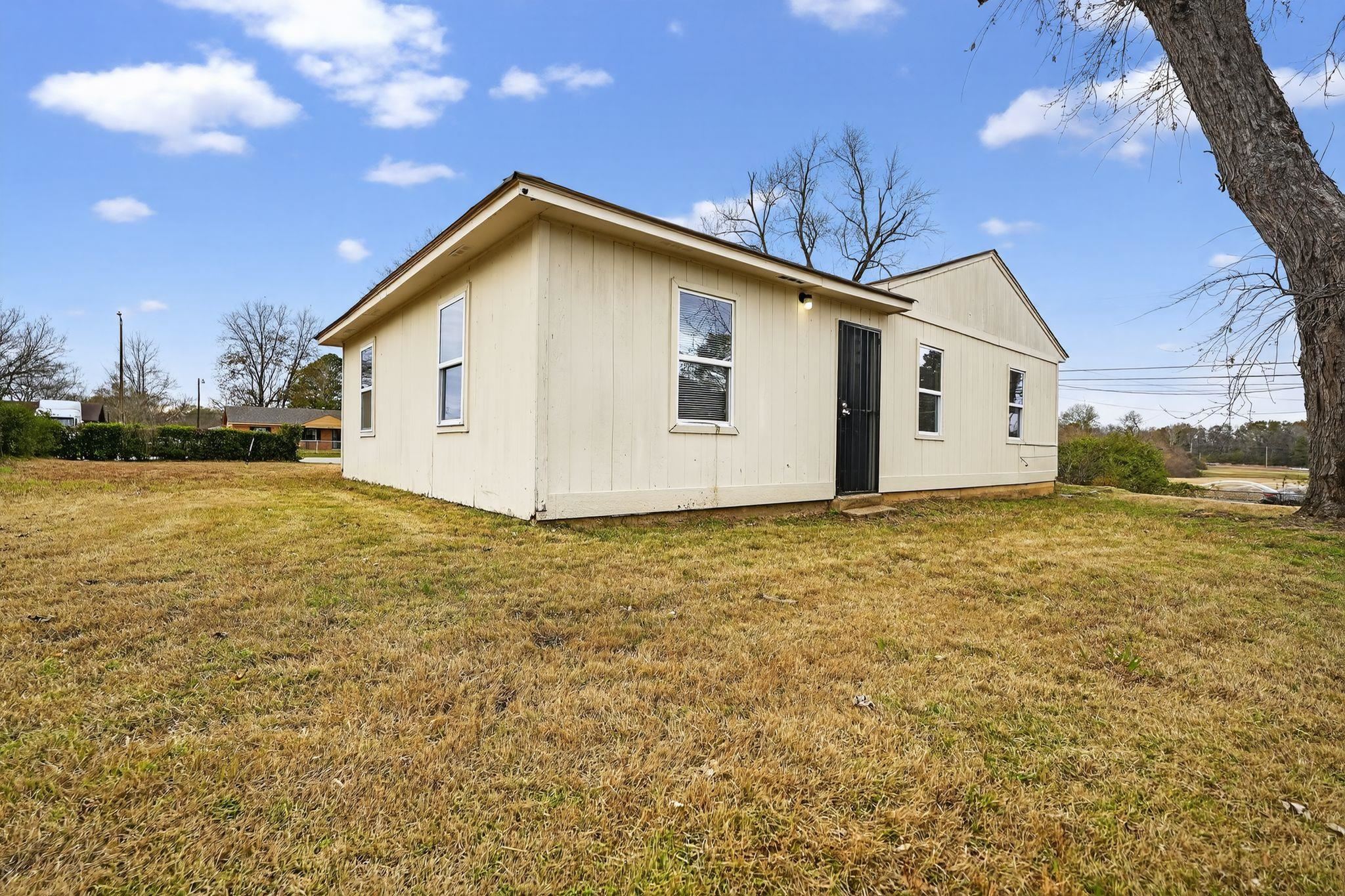 4314 Ford Road Memphis, TN 38109 - Photo 30 of 31 Back of house featuring a lawn
