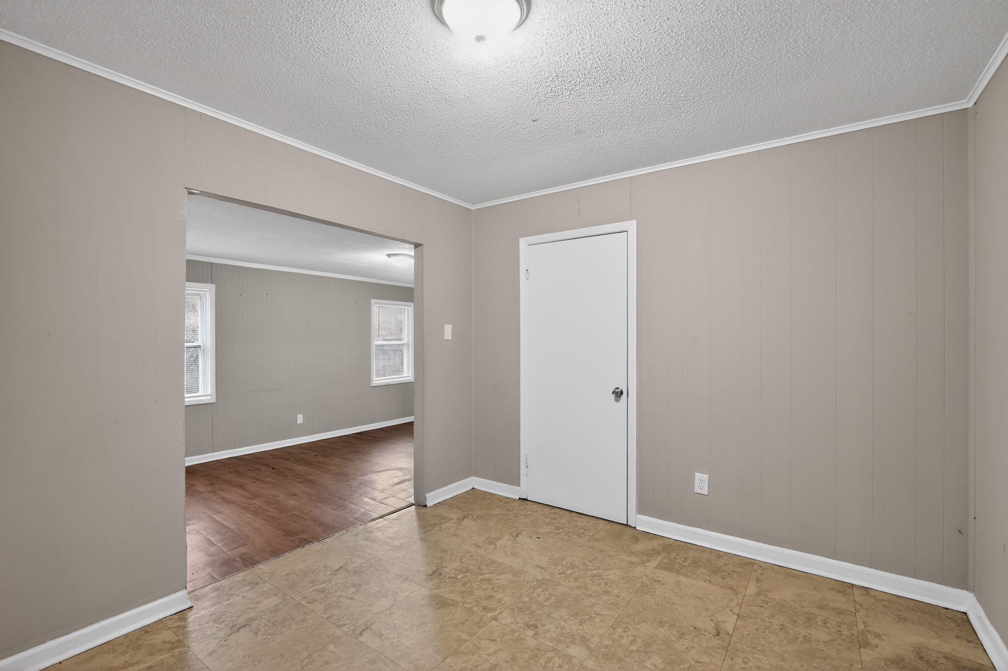 4314 Ford Road Memphis, TN 38109 - Photo 8 of 31 Empty room with ornamental molding and a textured ceiling