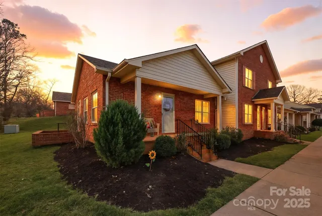 a view of a house with backyard garden and plants