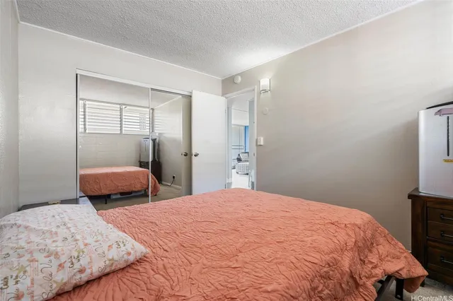 a bedroom with a bed and a tv