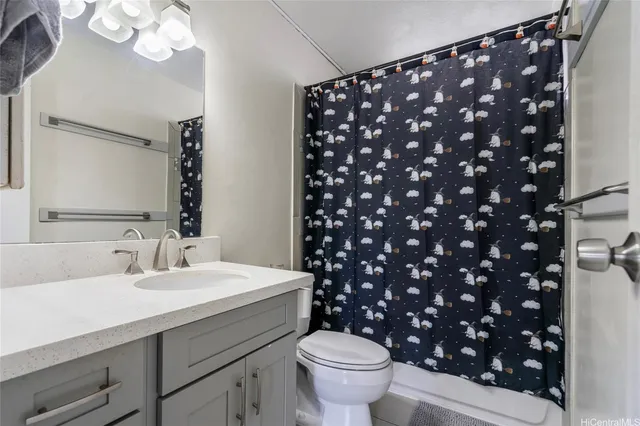 a bathroom with a sink mirror vanity and toilet