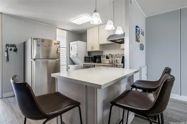 a kitchen with refrigerator cabinets dining table and chairs