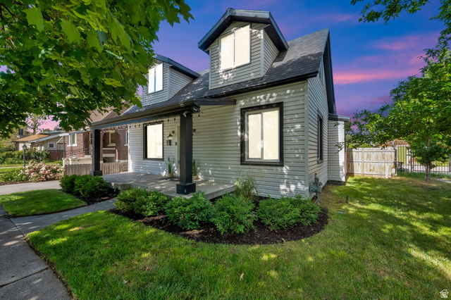 Charming bungalow exterior with light-colored siding and contrasting dark trim