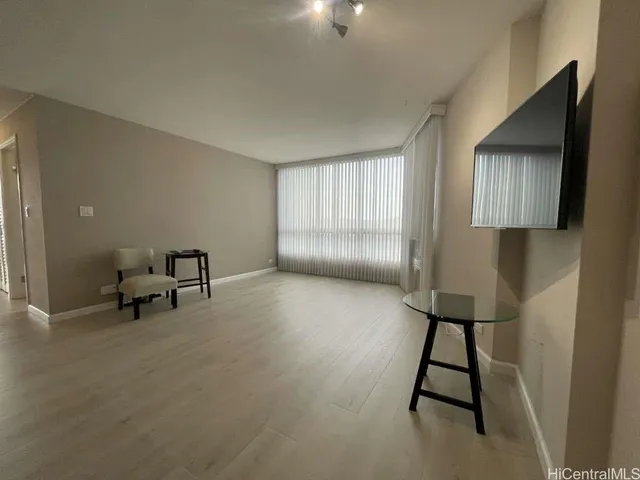 a living room with furniture and a lamp