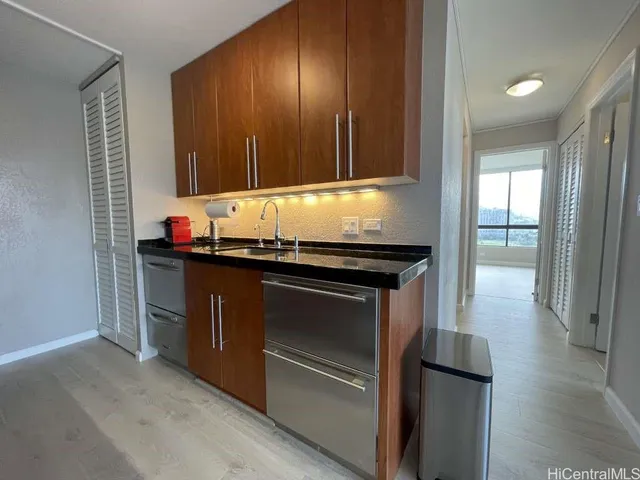 a kitchen with granite countertop stainless steel appliances and wooden cabinets
