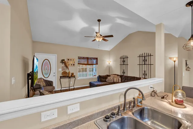 a view of a hallway with a sink and a mirror