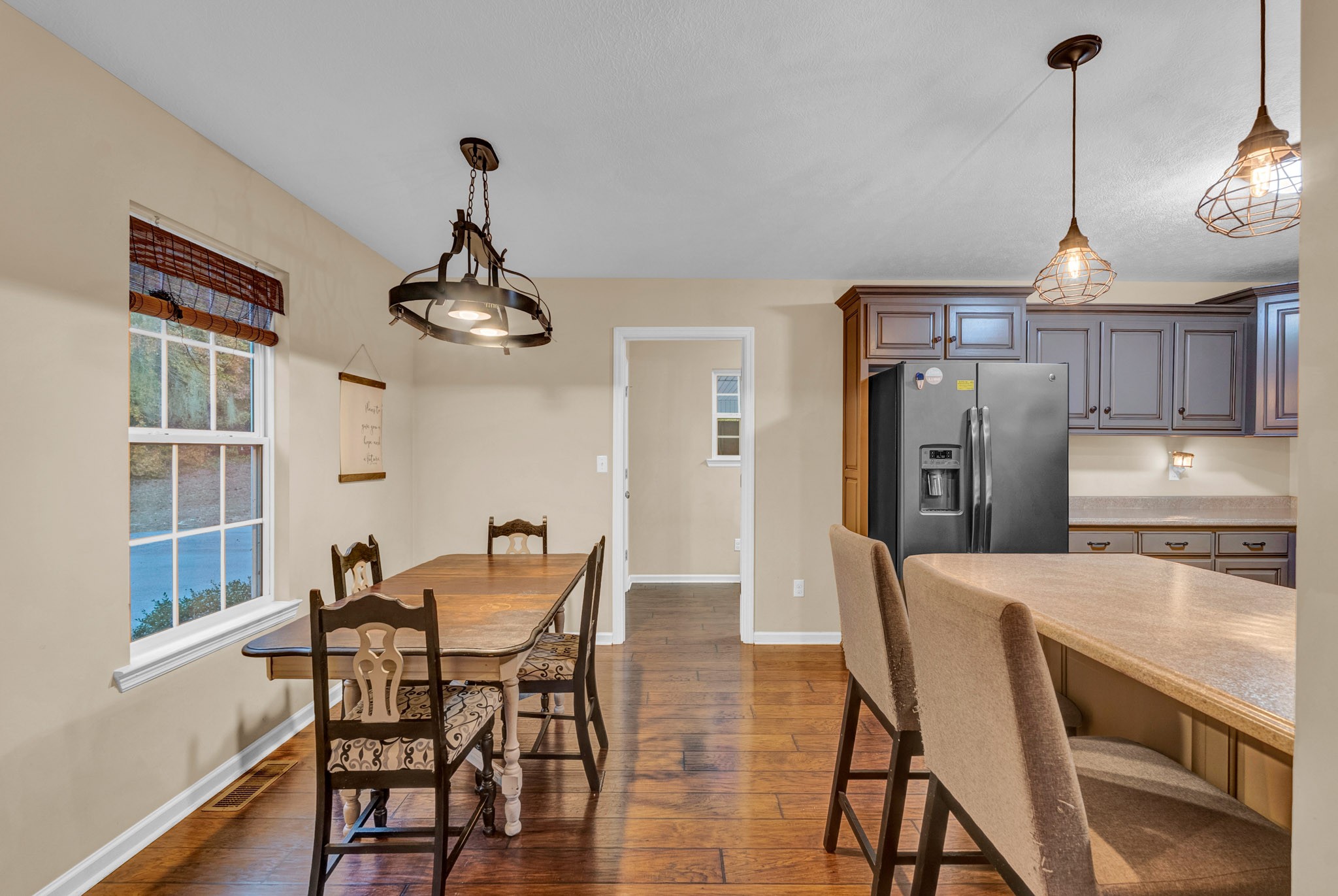 498 Bugger Ridge Road McMinnville, TN 37110 - Photo 12 of 22 a dining room filled chandelier and wooden floor