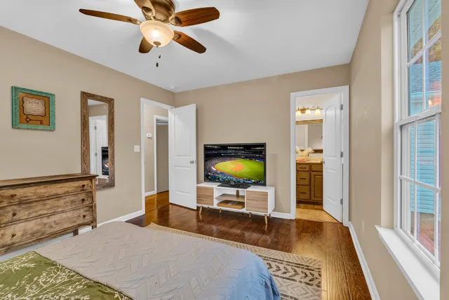 a bedroom with a bed and glass top table
