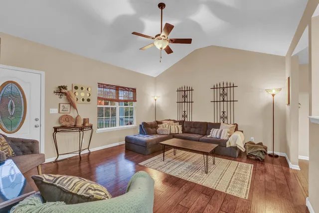a living room with furniture and a large window