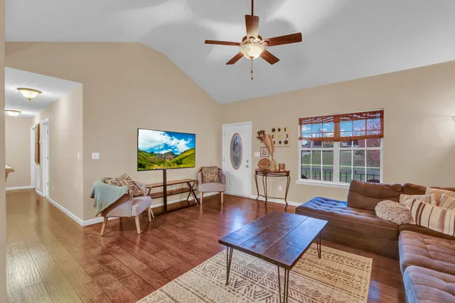 a living room with furniture a rug and a flat screen tv