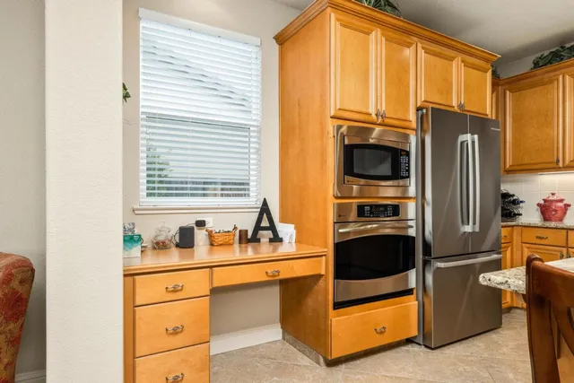 a kitchen with stainless steel appliances a refrigerator sink and cabinets
