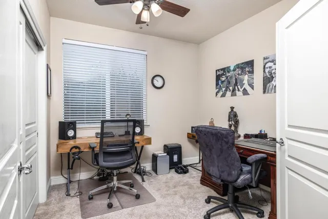 a view of a workspace with furniture and a window