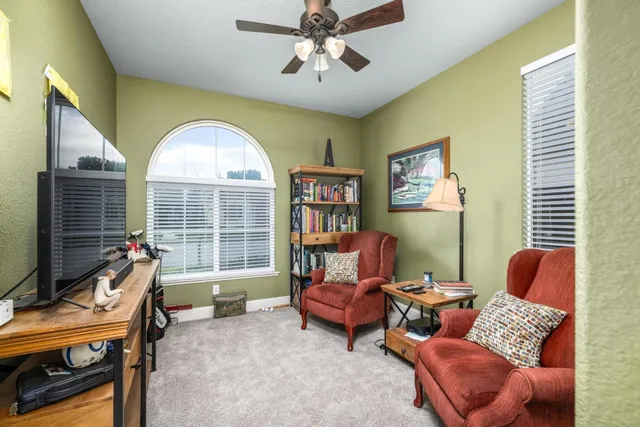 a living room with furniture and a large window