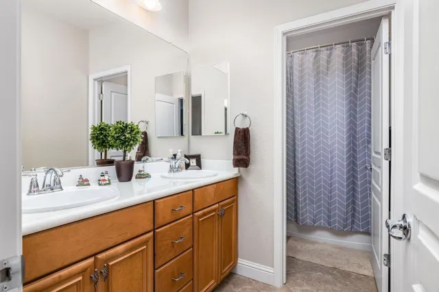 a bathroom with a double vanity sink and mirror